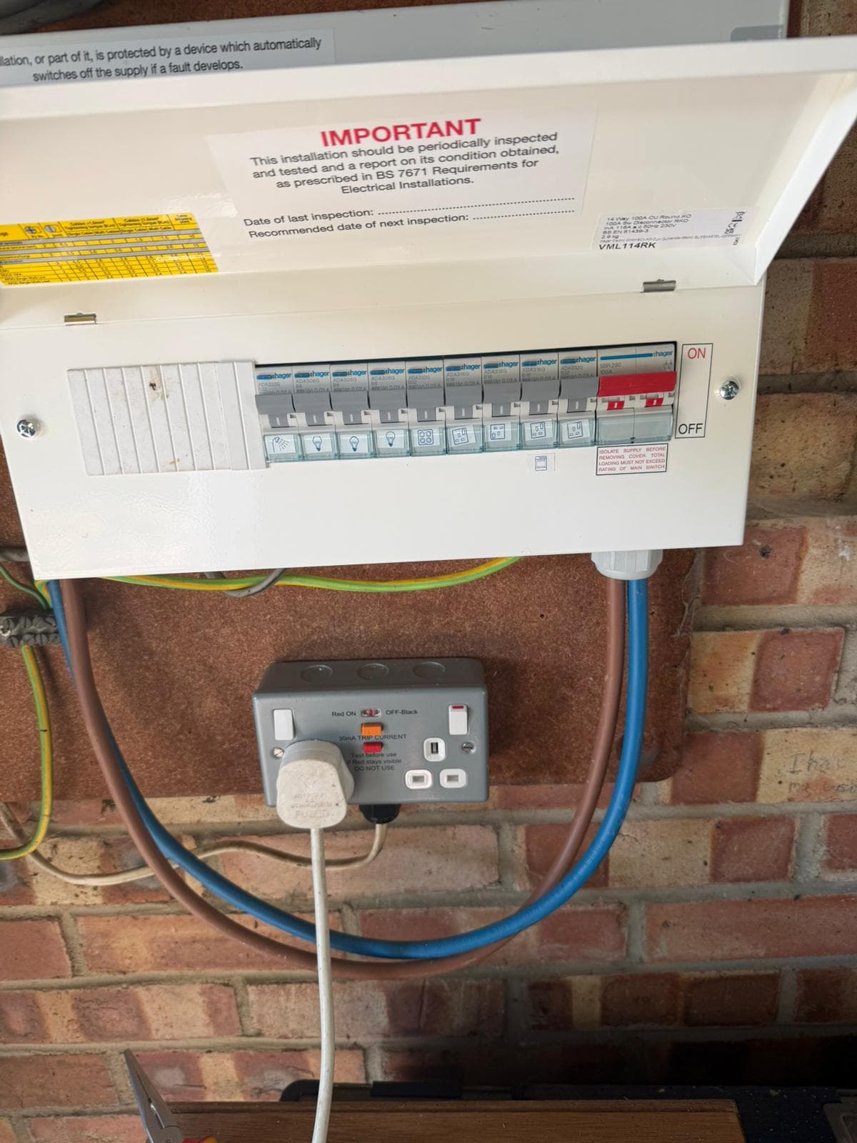 Hager consumer unit with RCBOs and a main switch, wired in on a brick wall