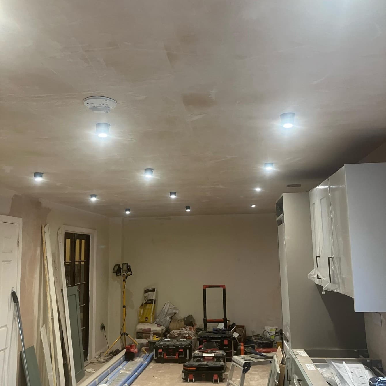 Recessed downlights wired into a freshly plastered kitchen ceiling